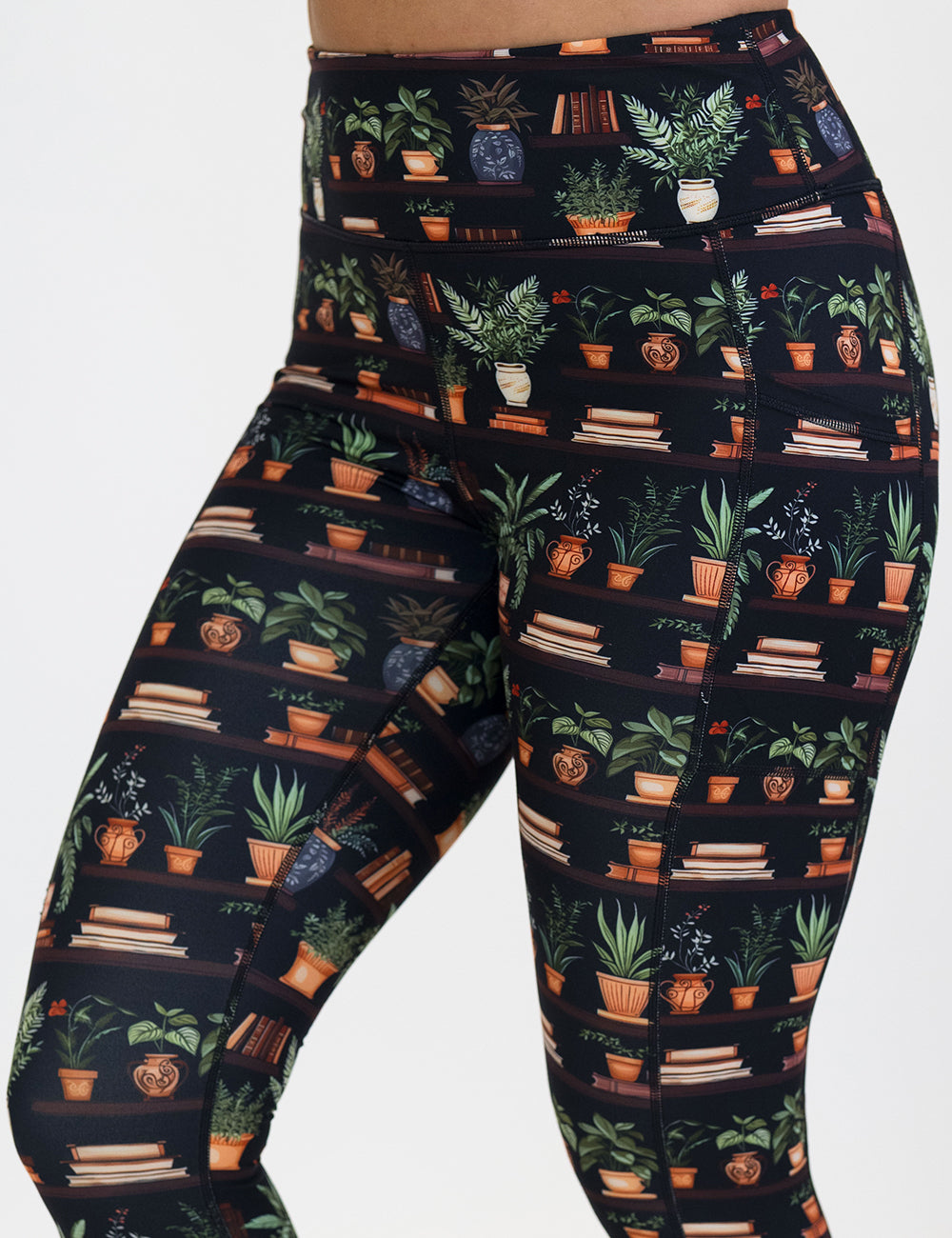 floral patterned leggings with books design on it against a white background