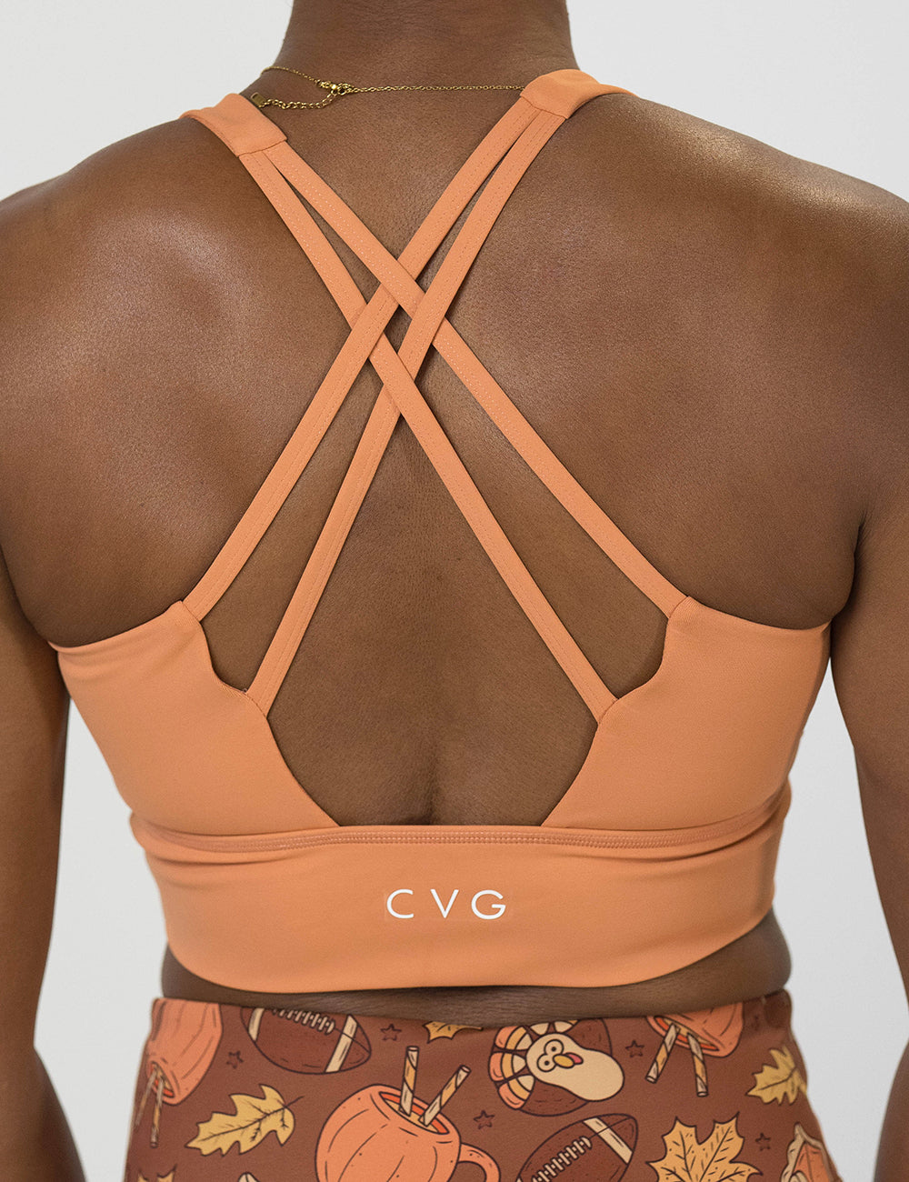 back of the peach-colored sports bra