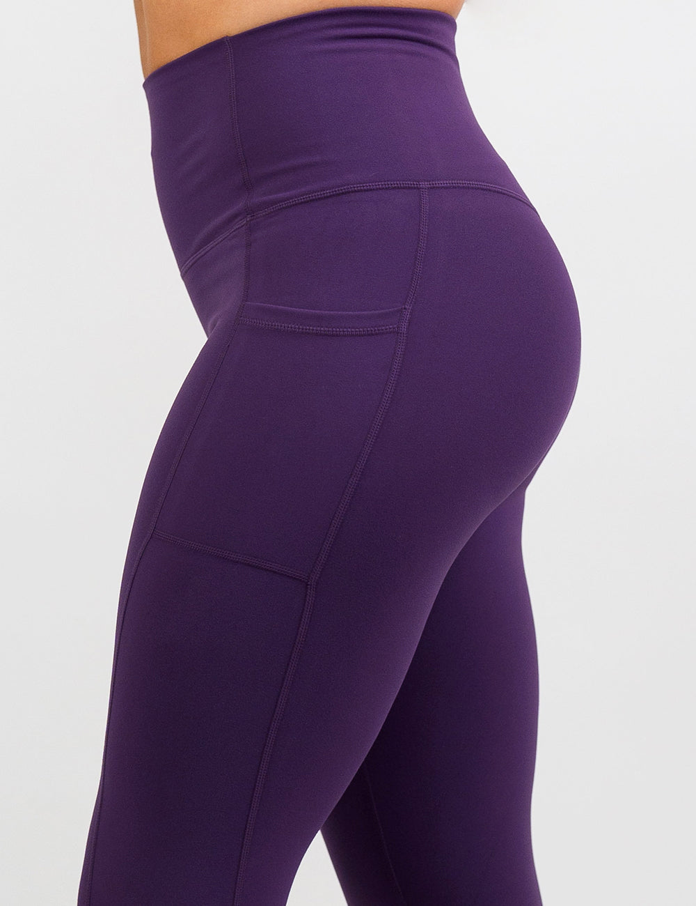 side of the solid purple leggings against a white background