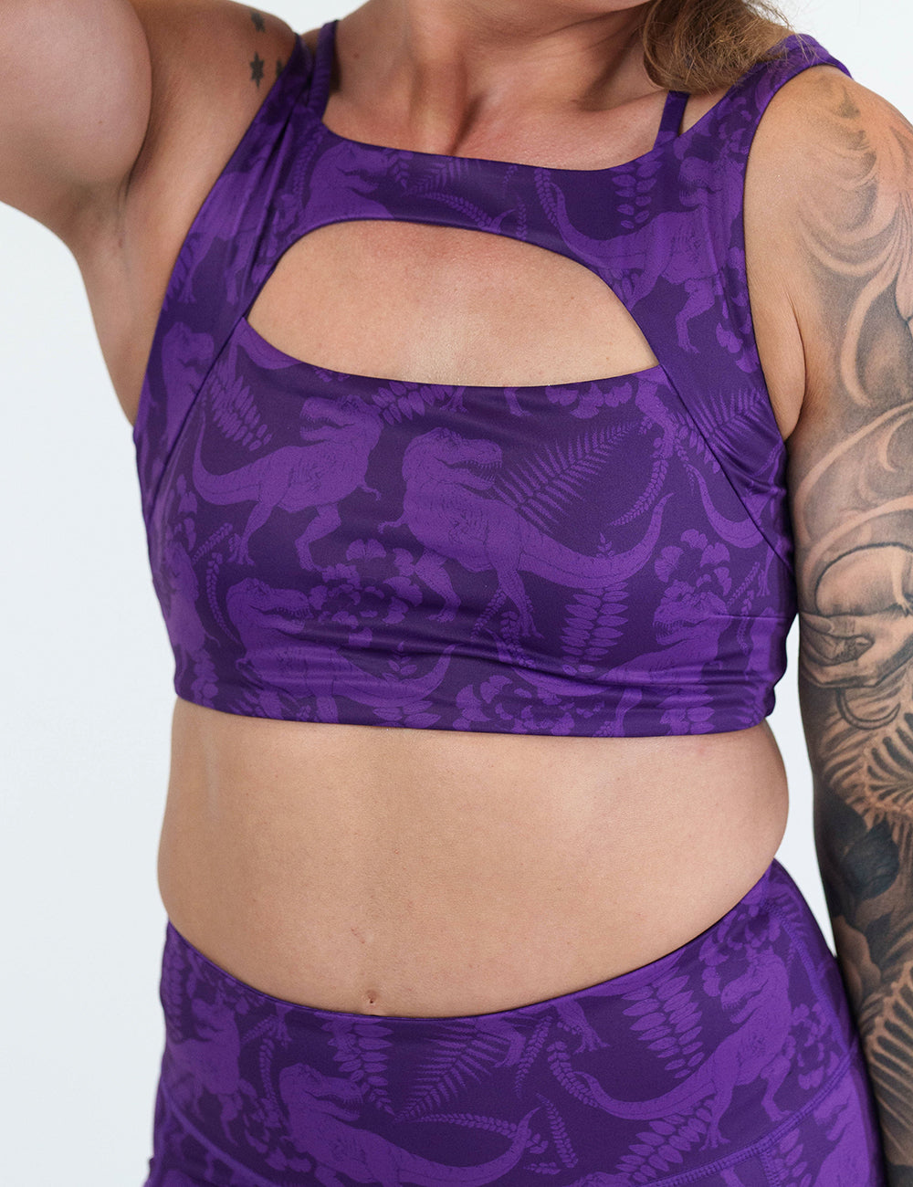 front of the purple dinosaur patterned sports bra