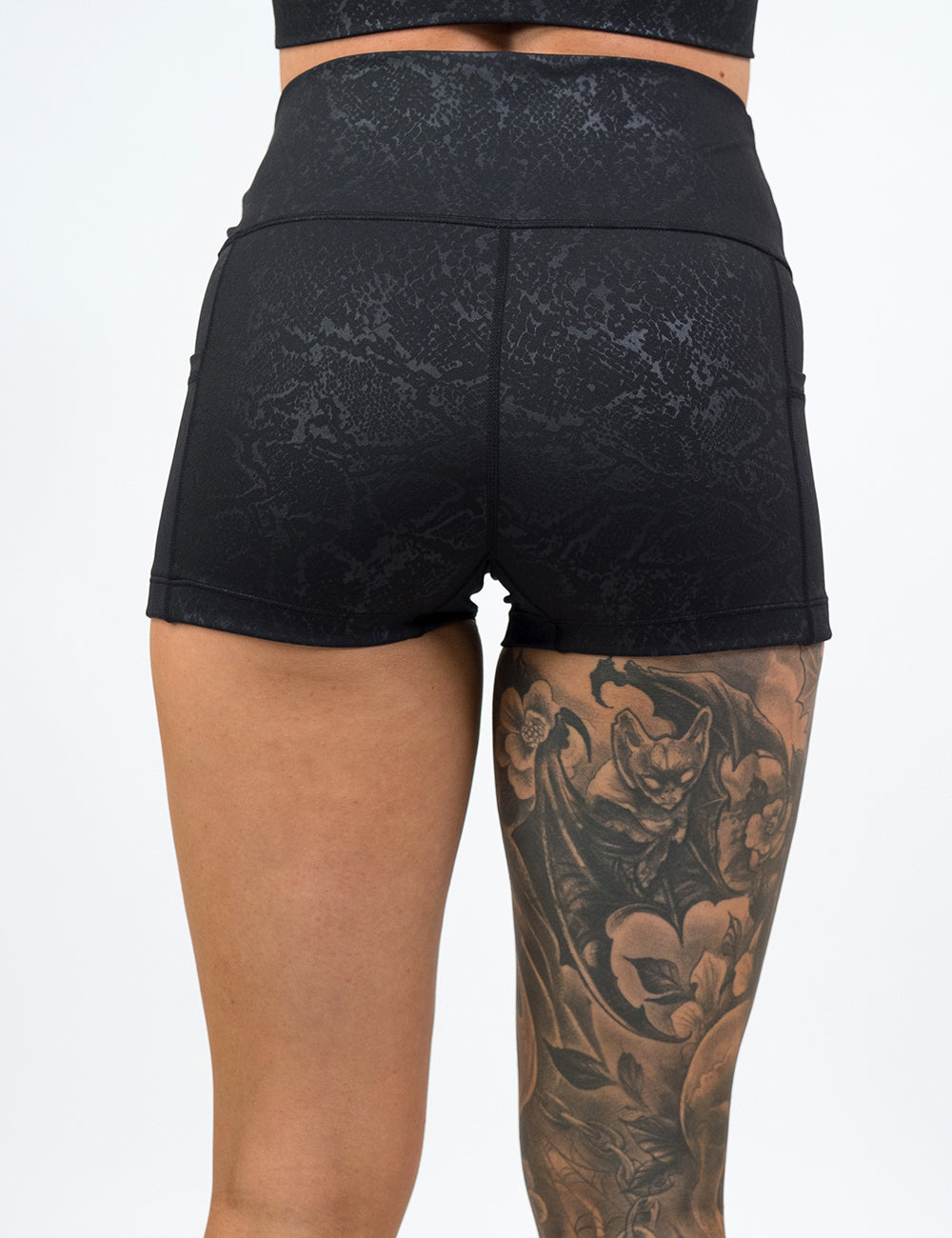 back of the 2.5 inch dark python print shorts against a white background