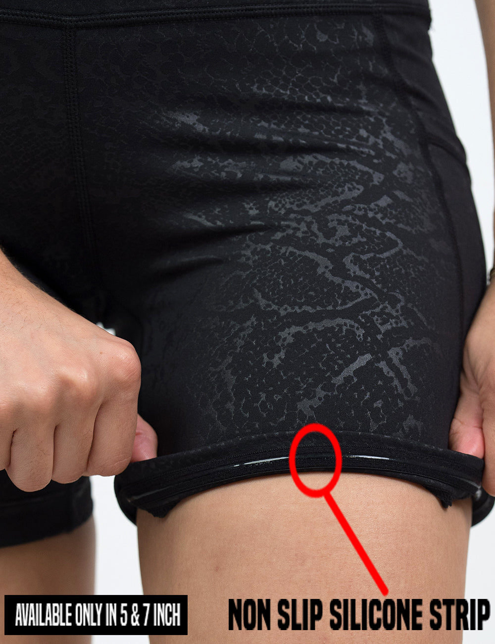 close up of the dark python print shorts rolled up to show the non slip silicone lining in the 5 and 7 inch shorts