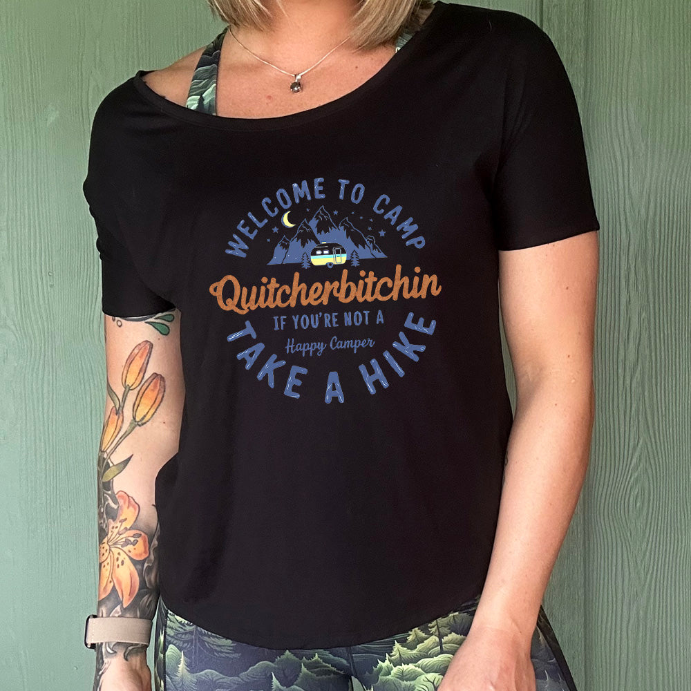 Black colored shirt with a mountain and campervan graphic on it that says "Welcome To Camp Quitcherbitchin if you're not a happy camper take a hike"