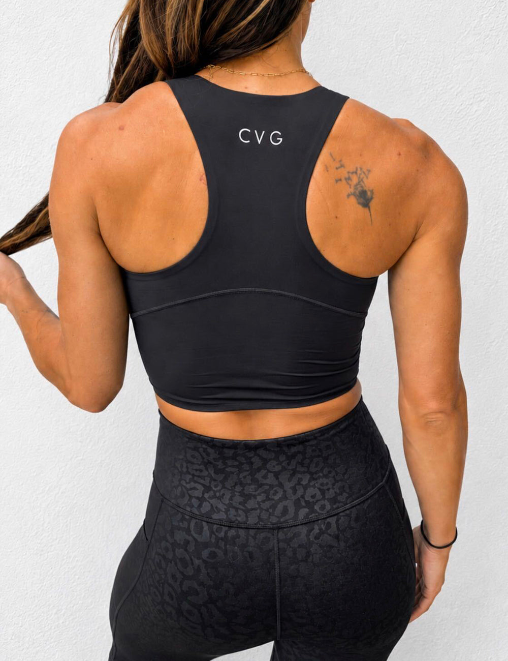 back of black racerback crop top with CVG logo at the top in white