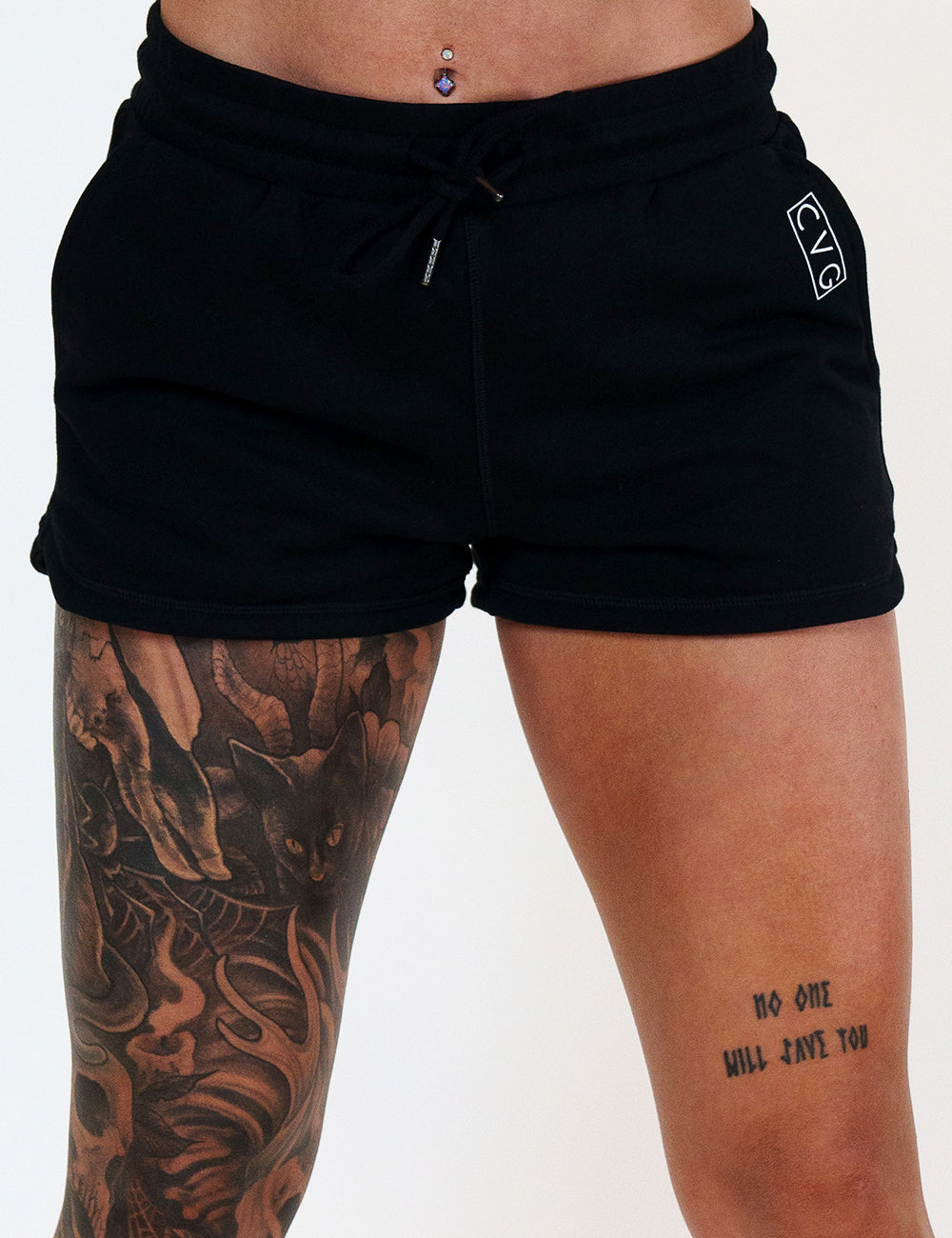 model wearing the black shorts against a white background