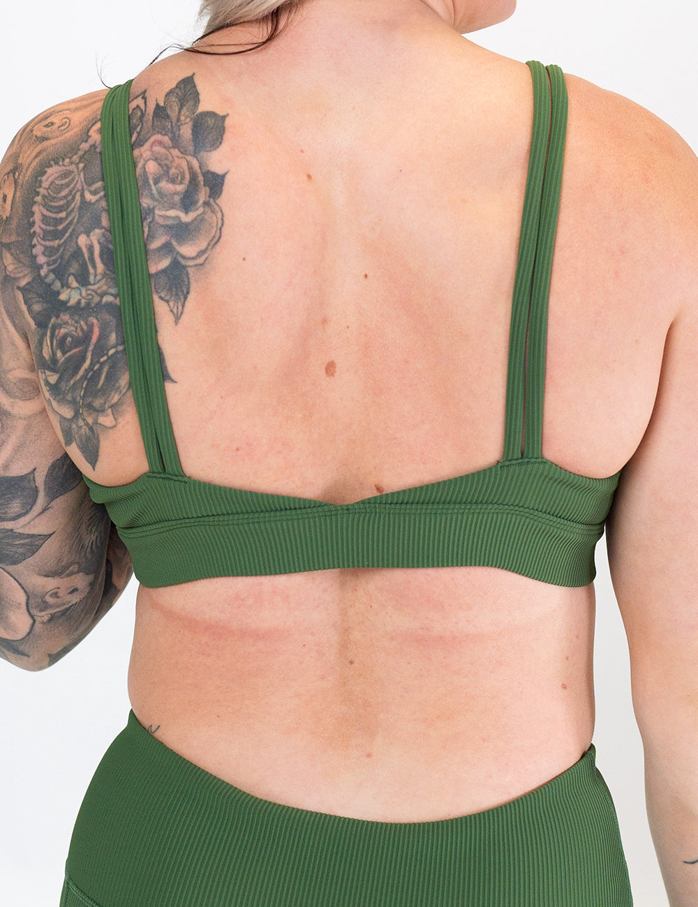 back of the green ribbed sports bra