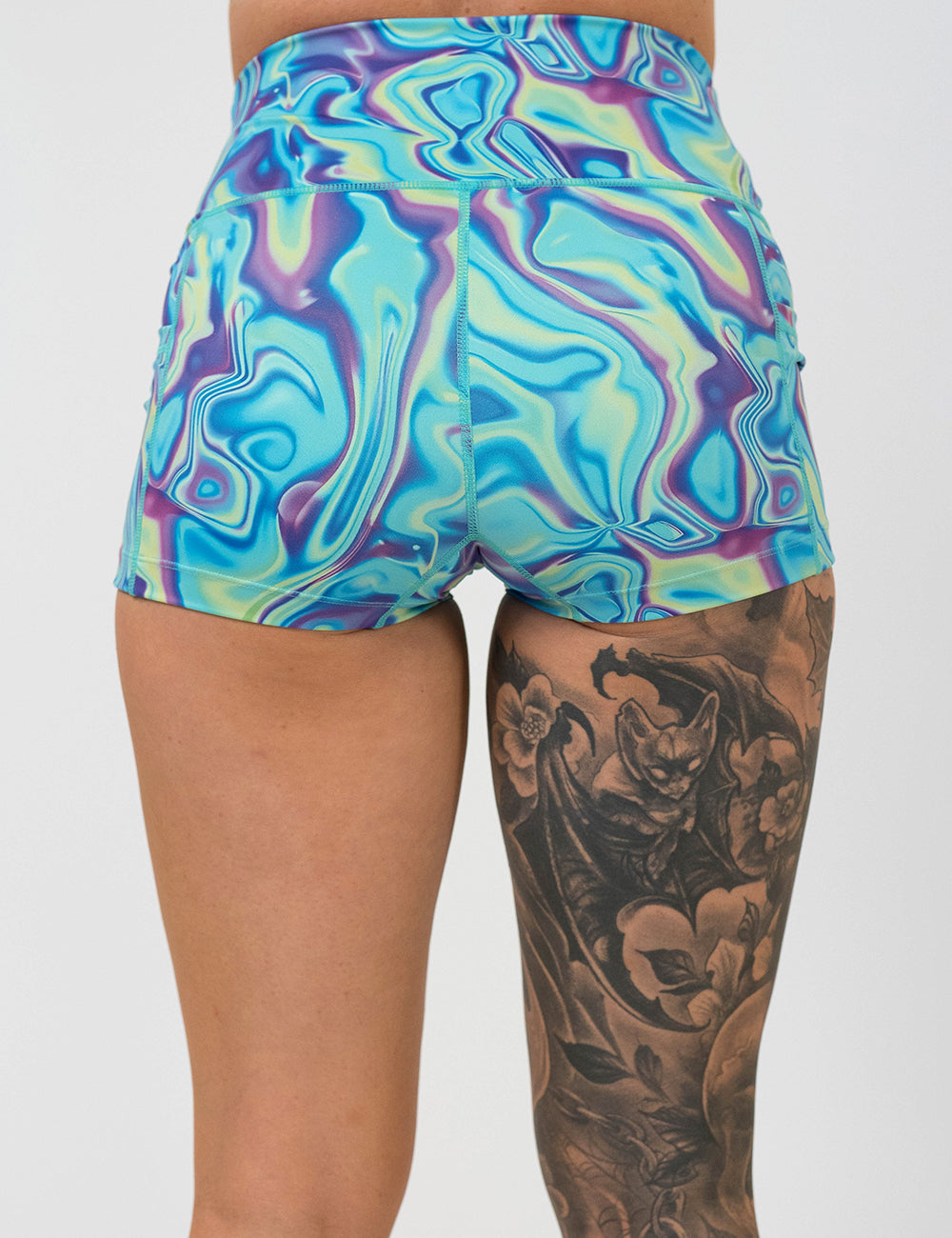 back of the 2.5 inch blue, green, and lavender liquid pattern shorts against a white background