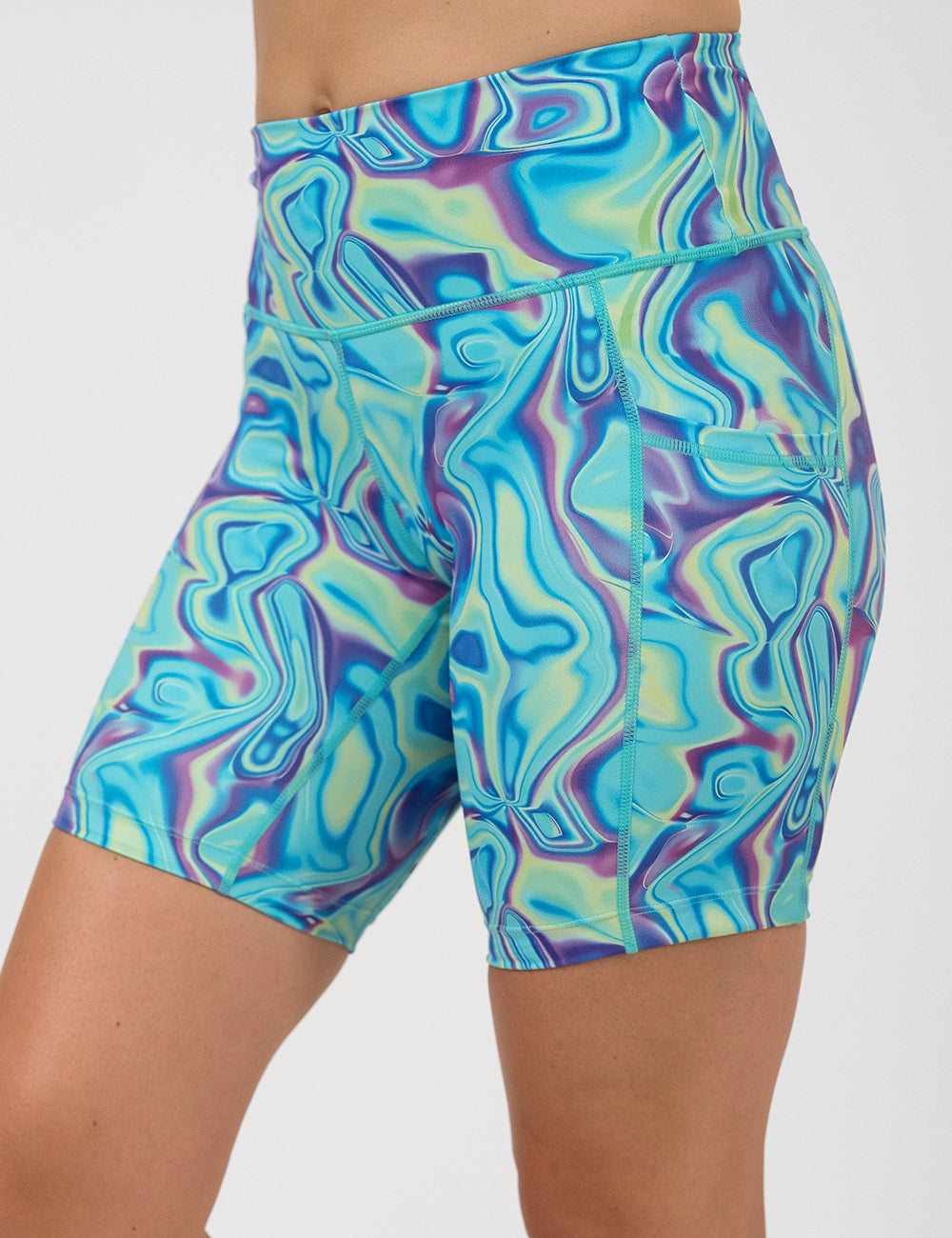 front of the 7 inch blue, green, and lavender liquid pattern shorts against  a white background