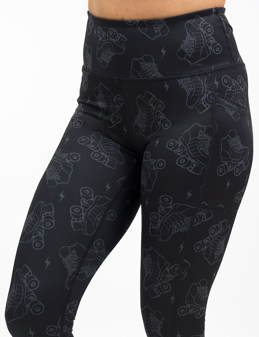 front of the dark roller skates and lighting print leggings against a white background