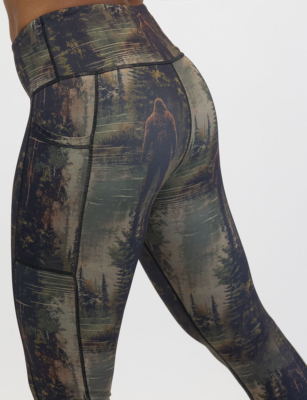 back of the bigfoot in a forest leggings against a white background
