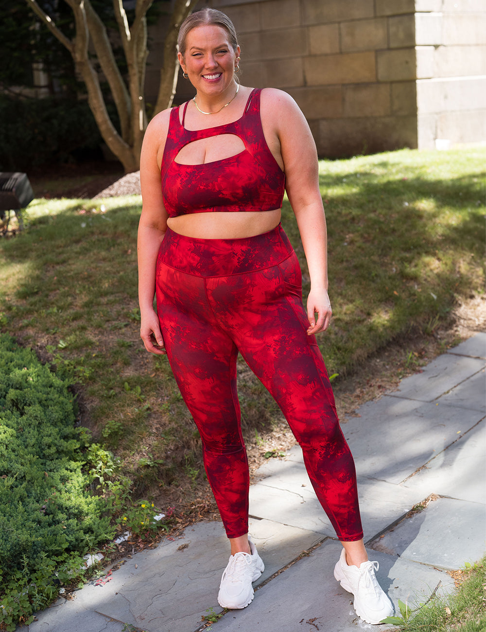 model wearing the full length red tie dye leggings and sports bra