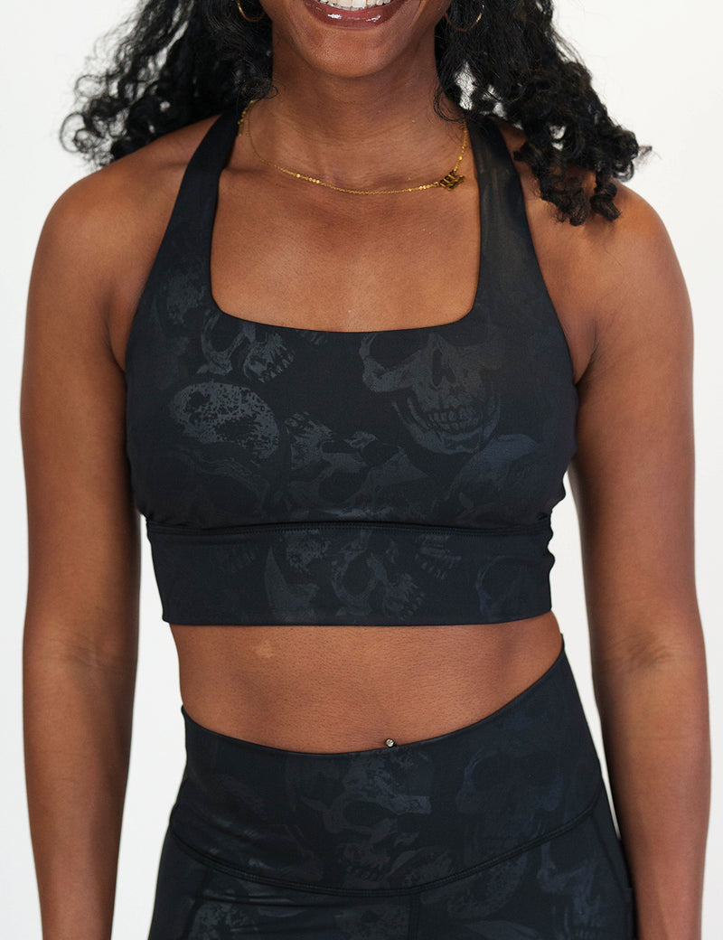 front of the black longline bra with a dark grey skull pattern against a white background