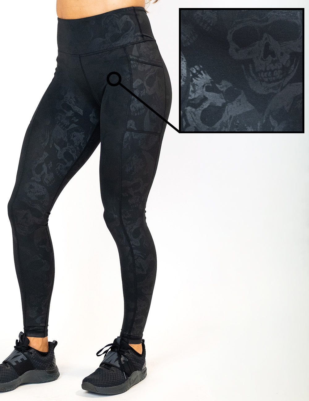 front of the black full length leggings with a dark grey skull pattern against a white background