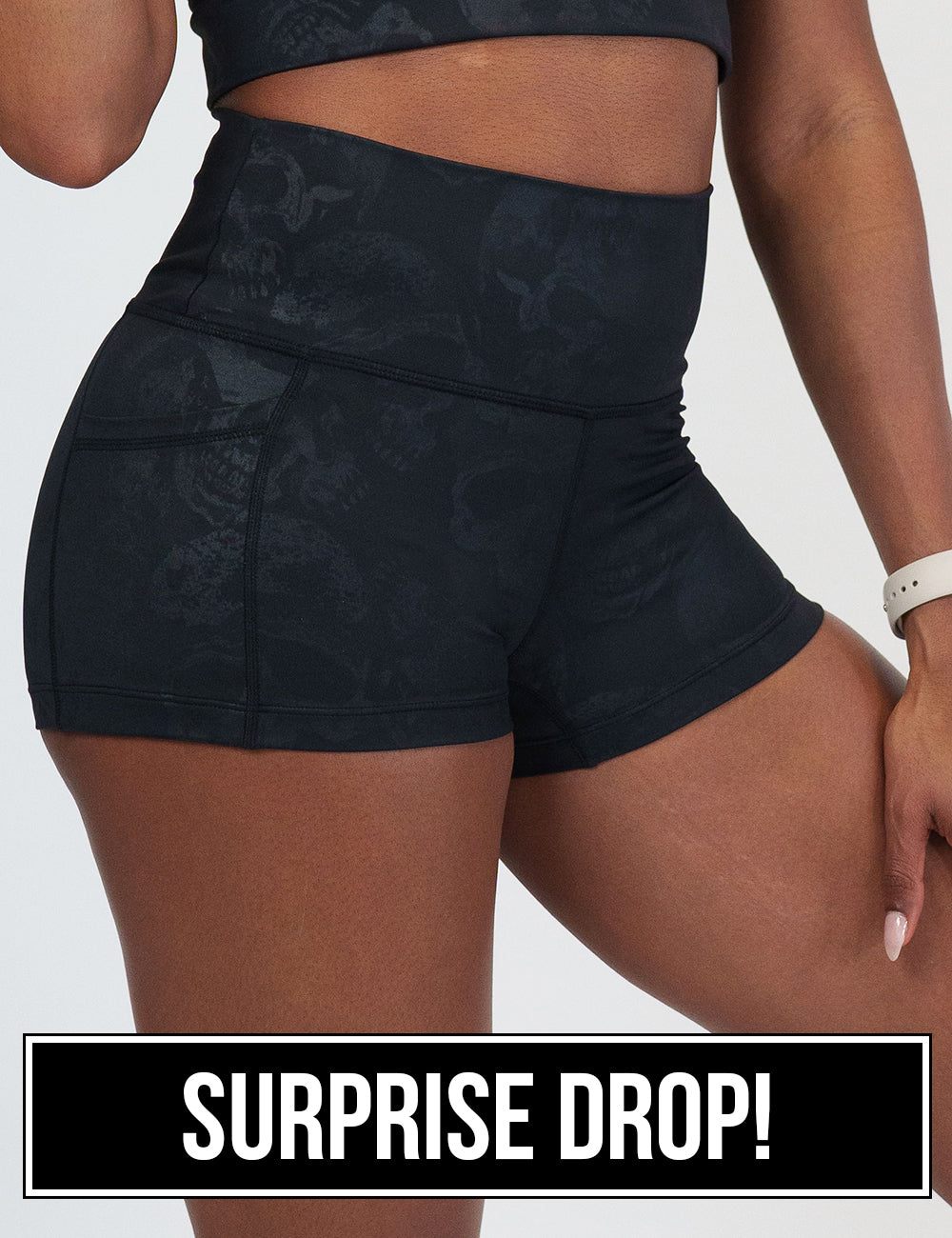 close up of the 2.5 inch black shorts with a dark grey skull pattern against a white background, surprise drop