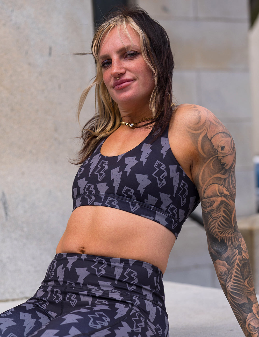 model wearing the black butterfly back bra with a grey thunderbolts pattern