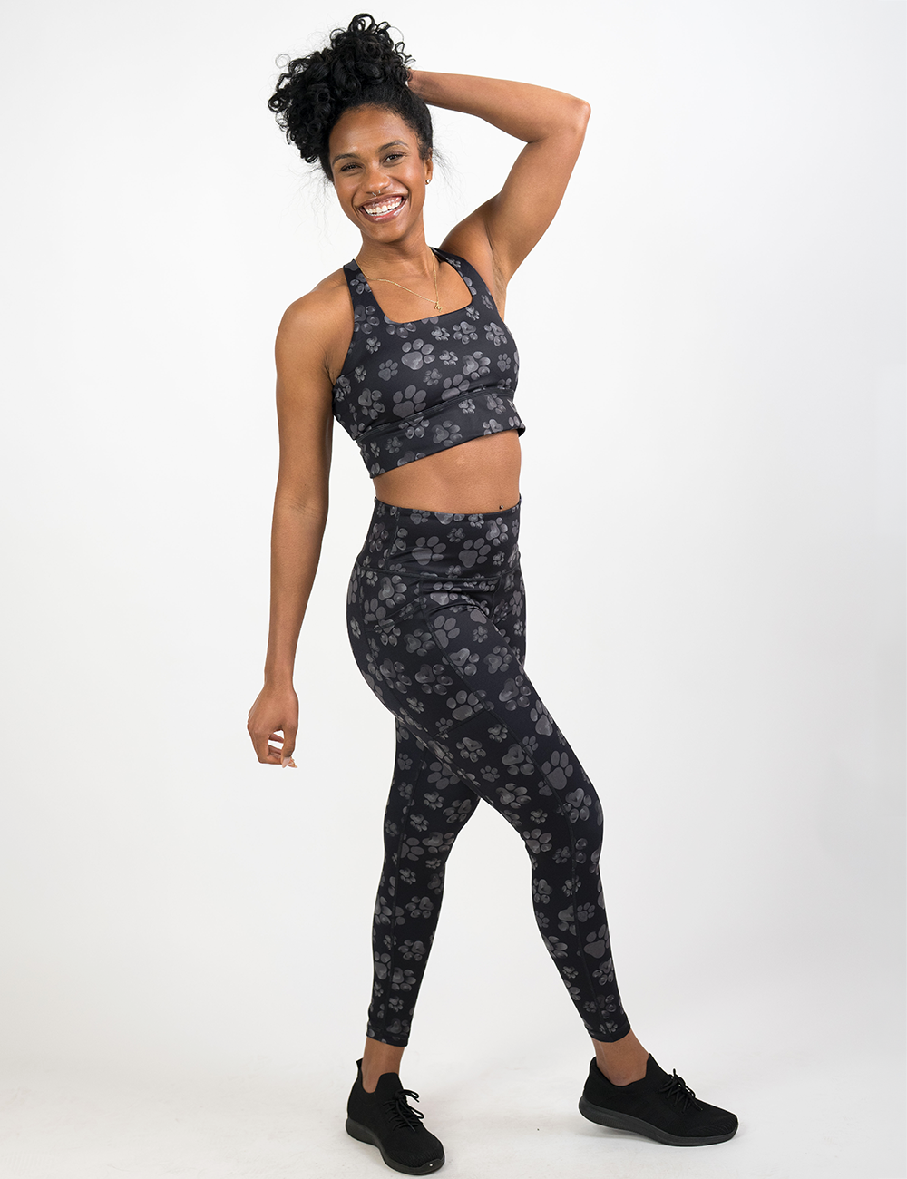 model wearing the grey paw print full length leggings against a white background