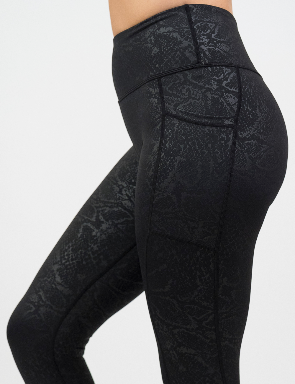 close up of black snake print leggings