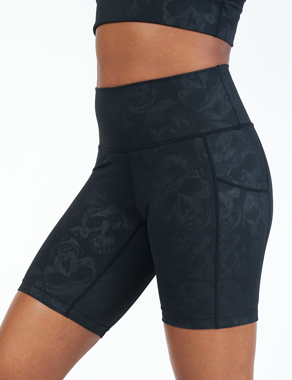 close up of the 7 inch black skulls on a black background shorts against a white background