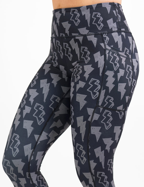 front of the black leggings with grey lightning bolts against a white background