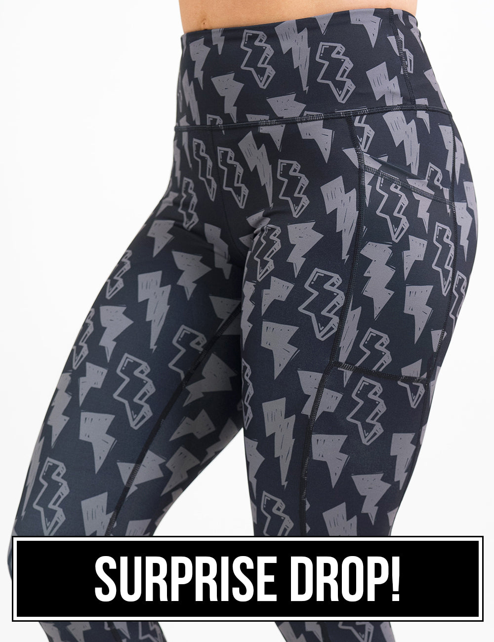 front of the black leggings with grey lightning bolts against a white background, surprise drop