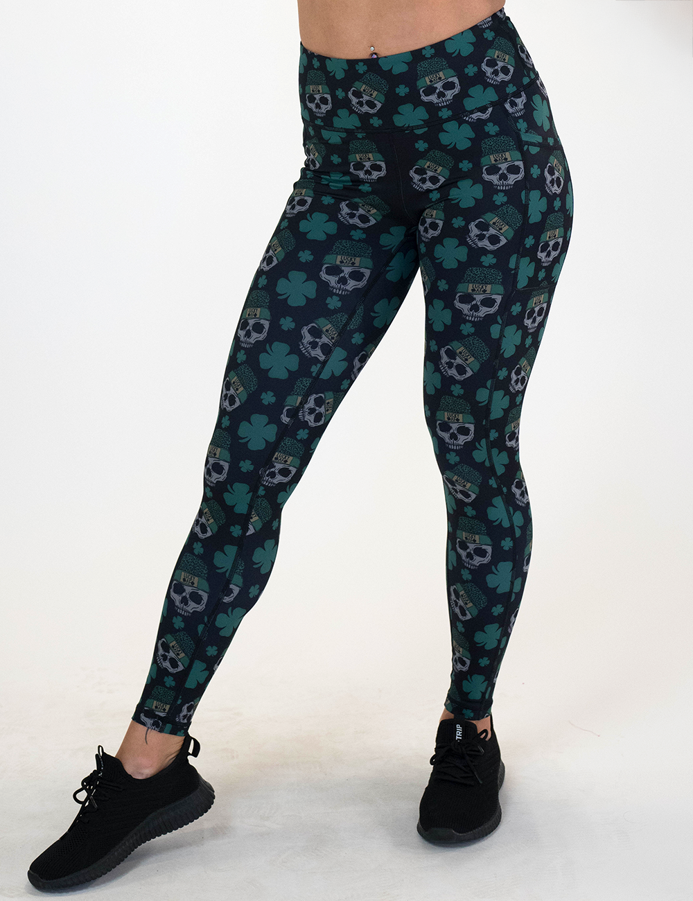 model is wearing the full length shamrock and skull pattern leggings against a white background