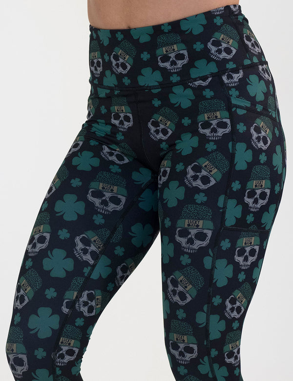 close up of the skull and shamrock print leggings against a white background