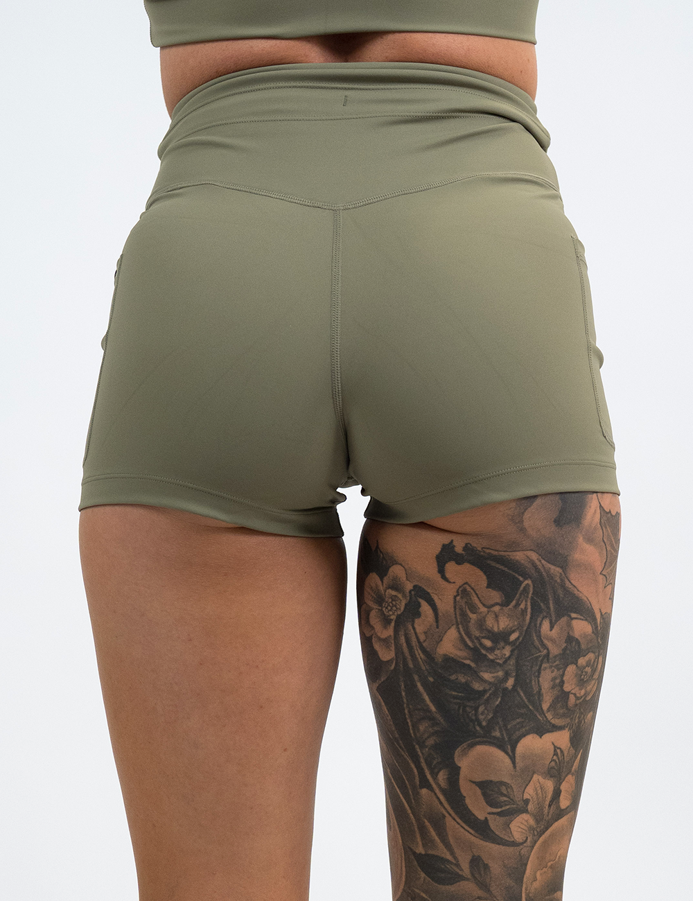 back of the 2.5 inch solid green omni shorts against a white background