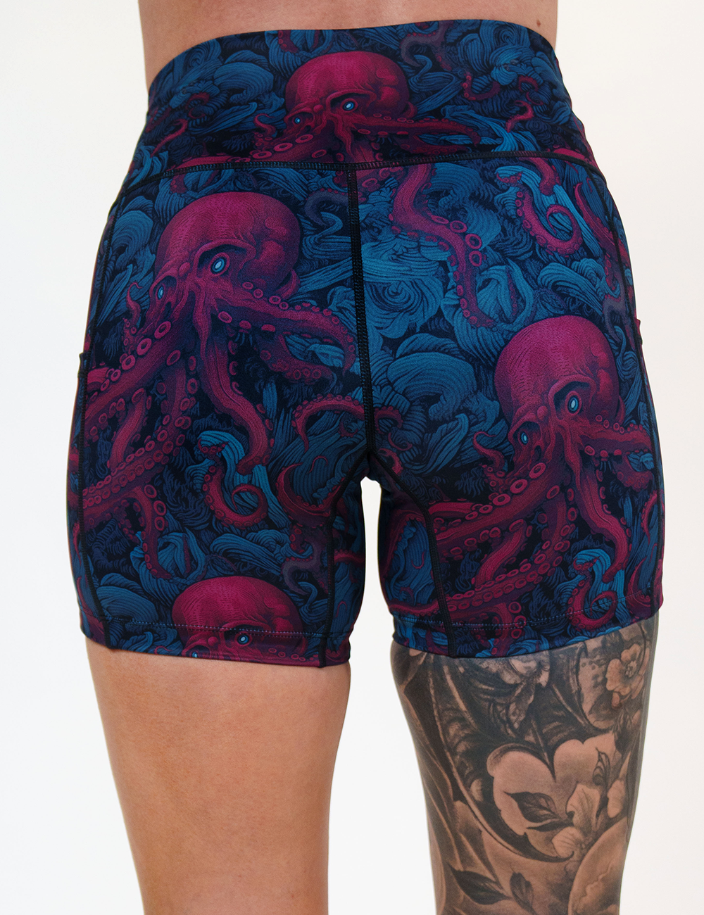 back of the 5 inch maroon octopus with blue eyes shorts against a white background