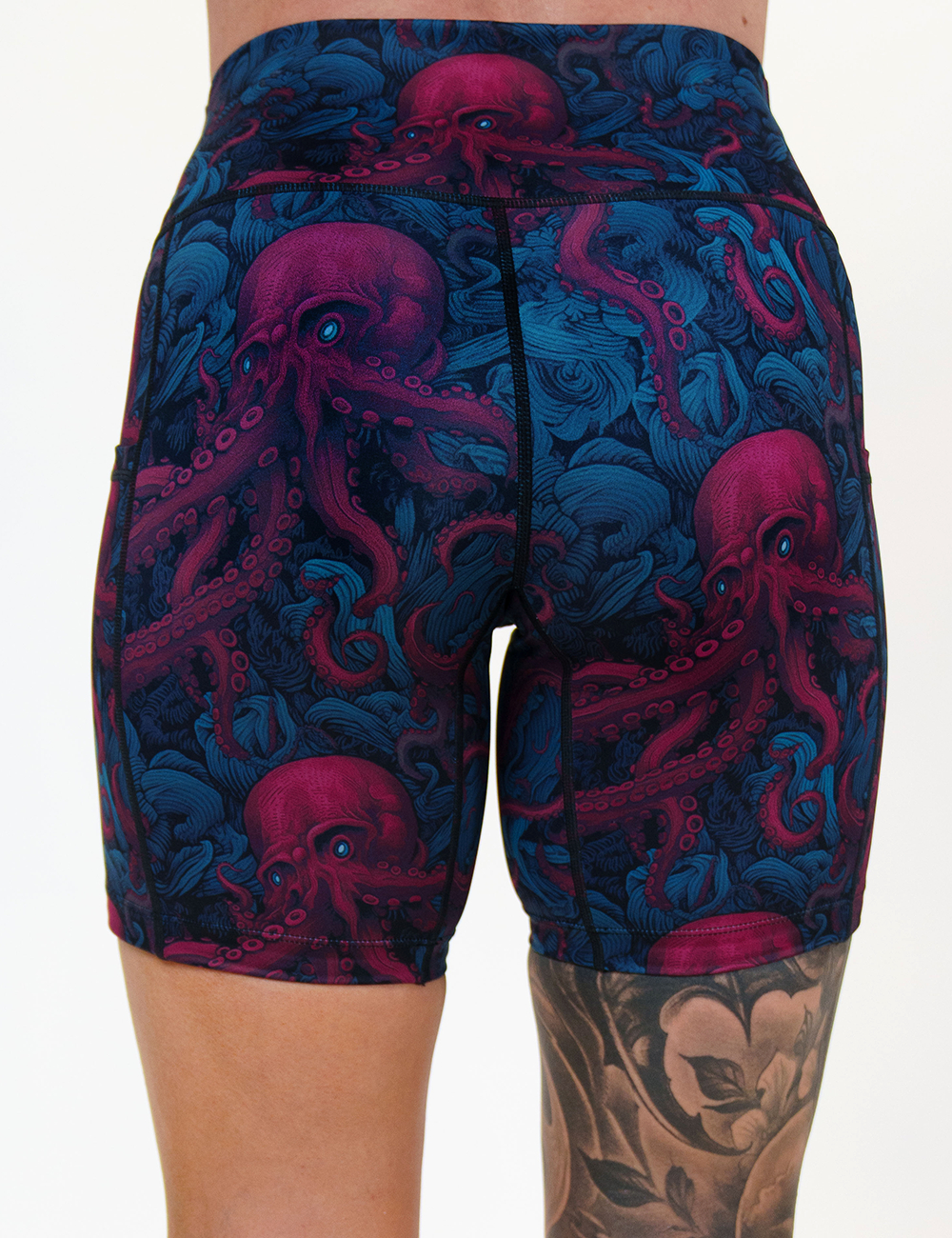 back of the 7 inch maroon octopus with blue eyes shorts against a white background