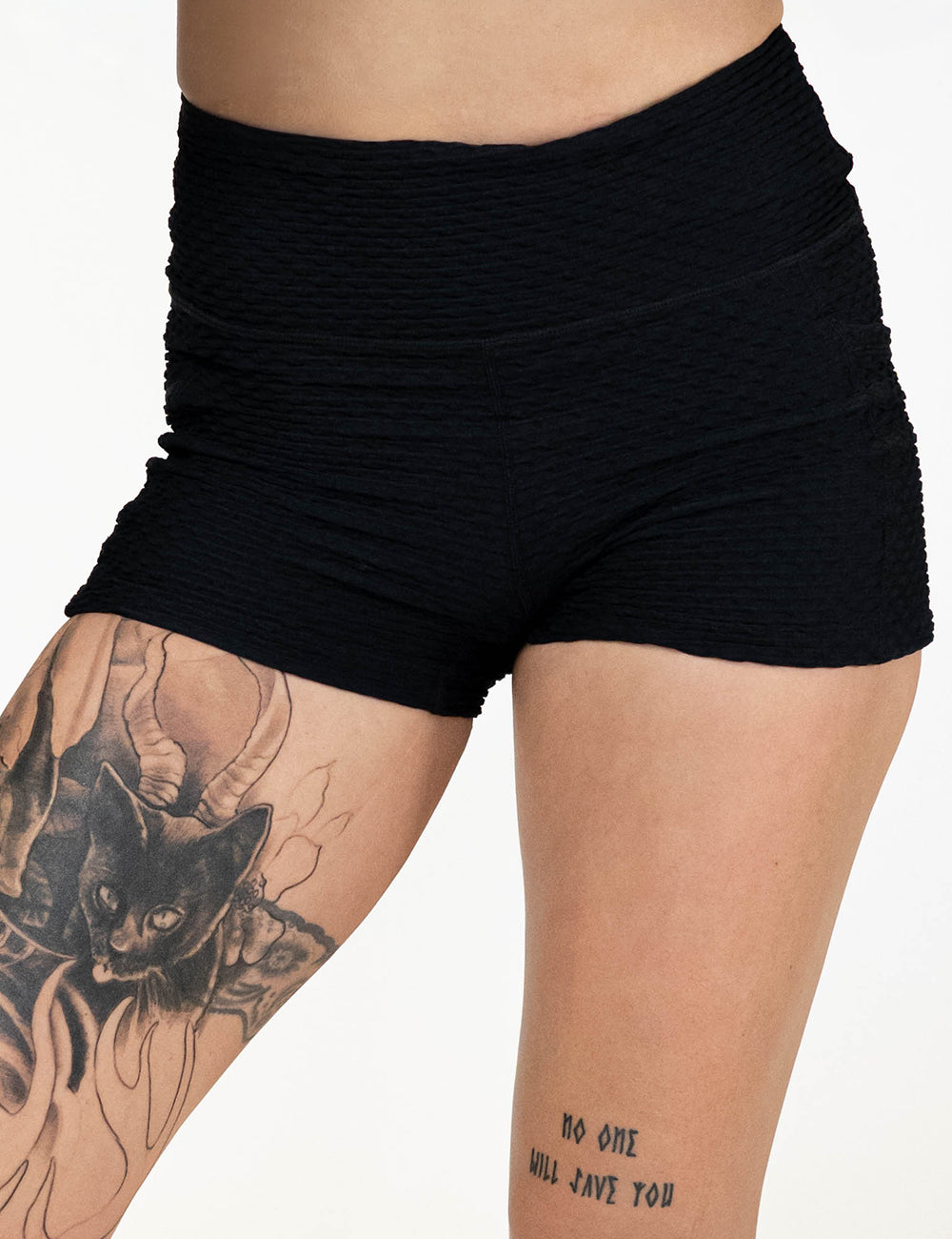 front of the 2.5 inch black waffled texture shorts against a white background