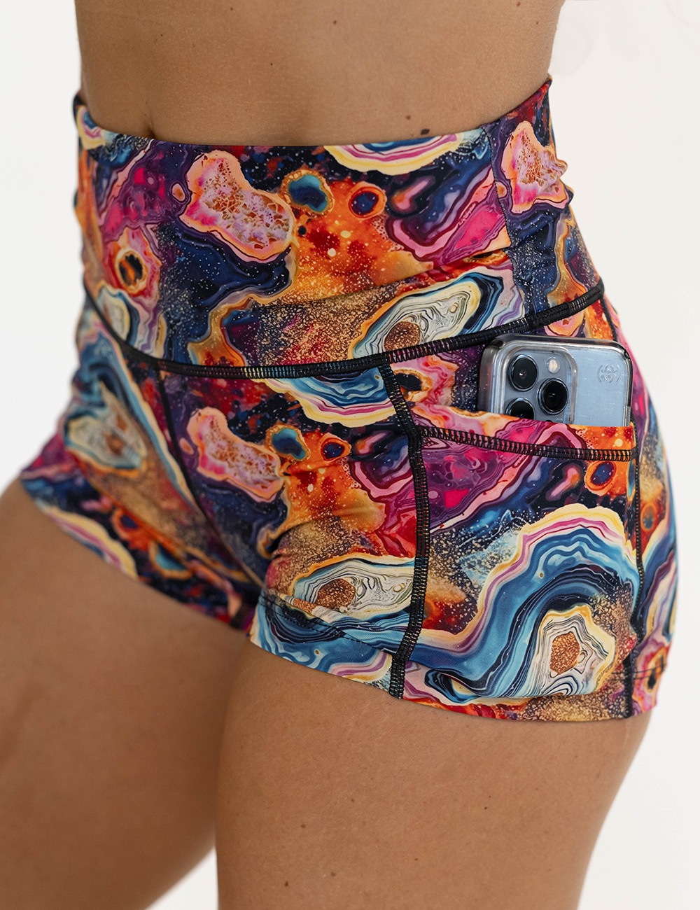 close up of the 2.5 inch colorful granite shorts pocket holding a phone against a white background