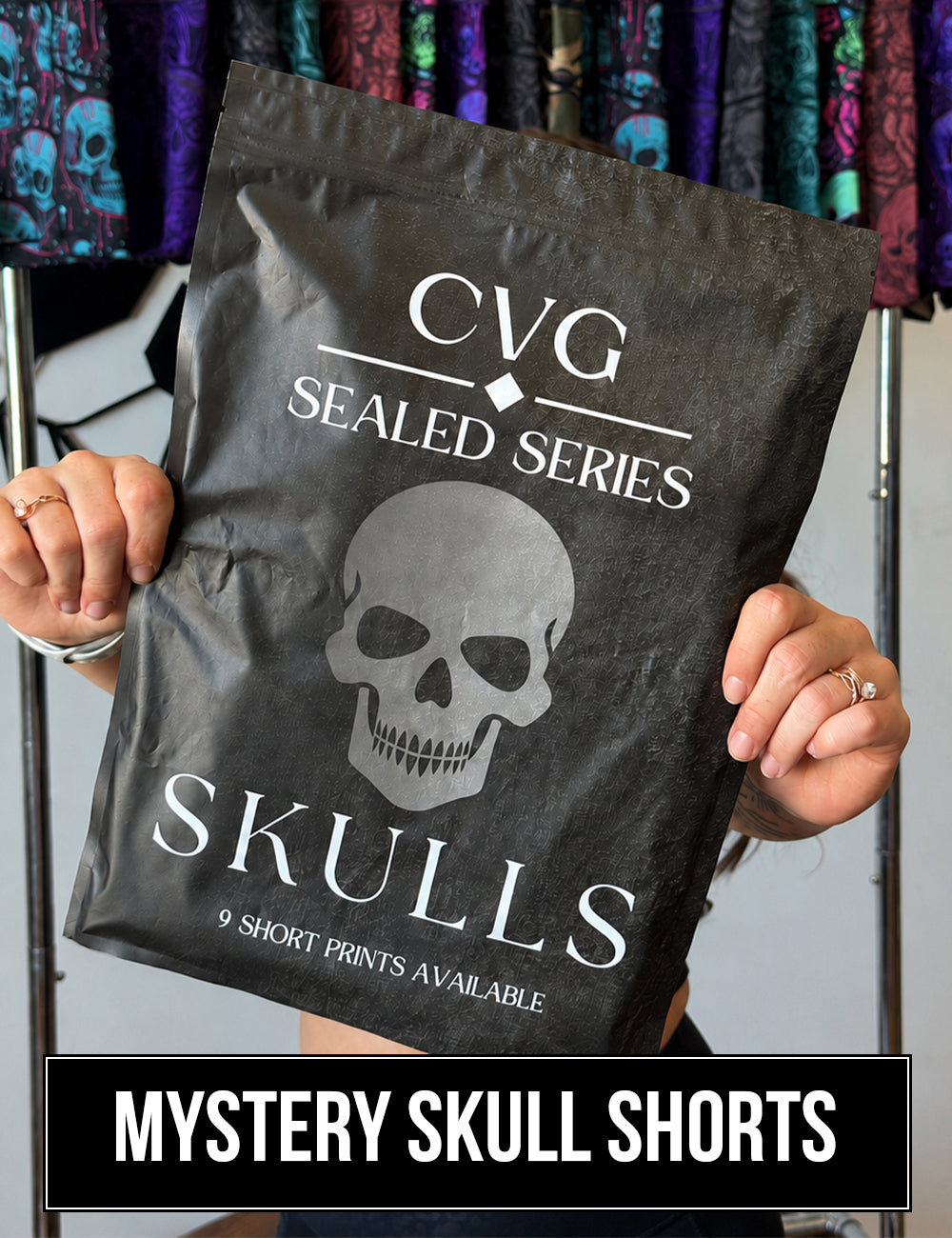 front of the CVG Sealed Series: Skulls Bag featuring a blacked out design with a grey skull in the middle, 9 shorts prints are available