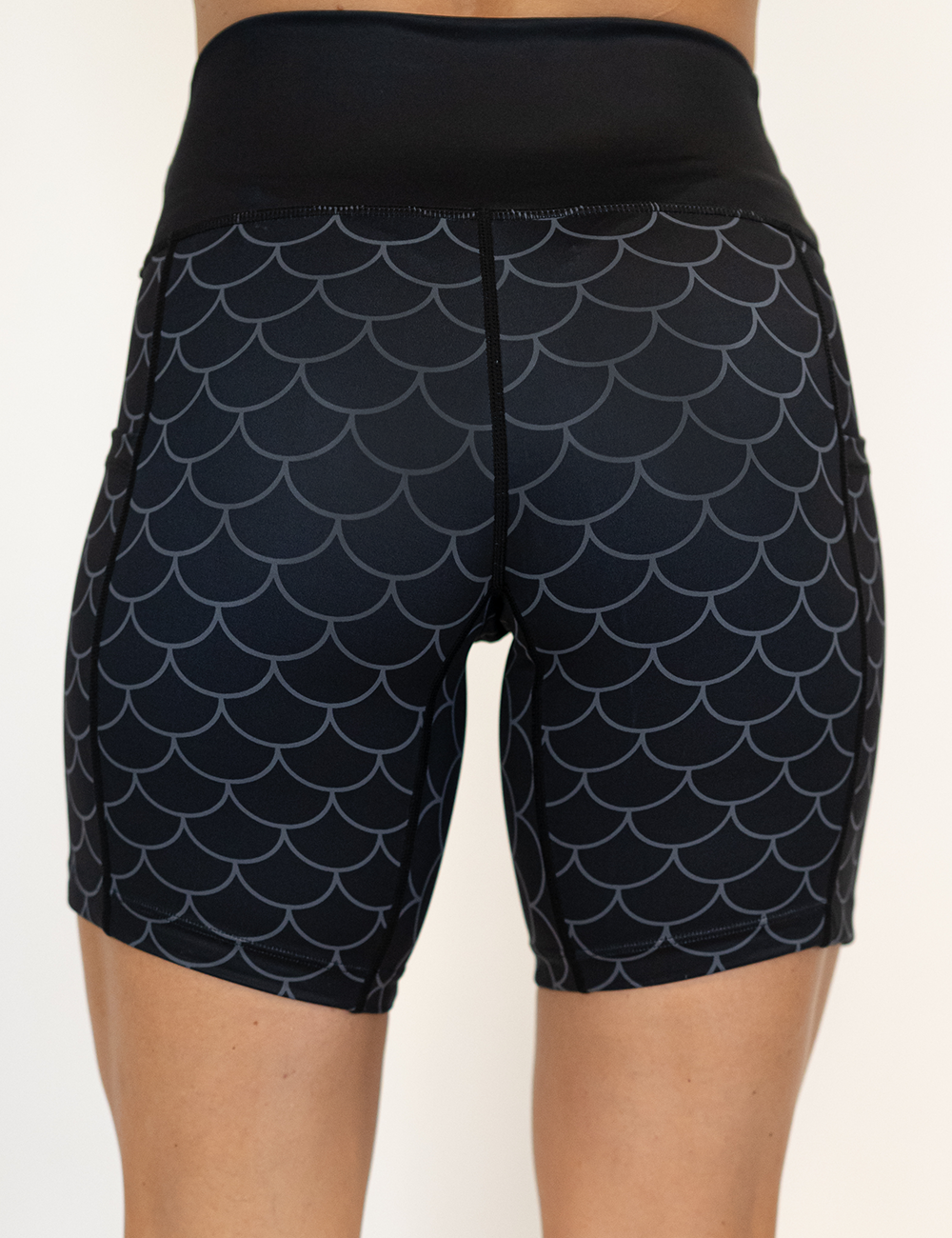 back of the dragon scale outline against a dark background pattern 7 inch shorts against a white background