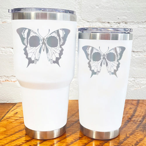 white tumblers with silver skull butterfly in the center