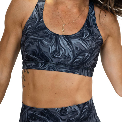front of grey and black swirl sports bra