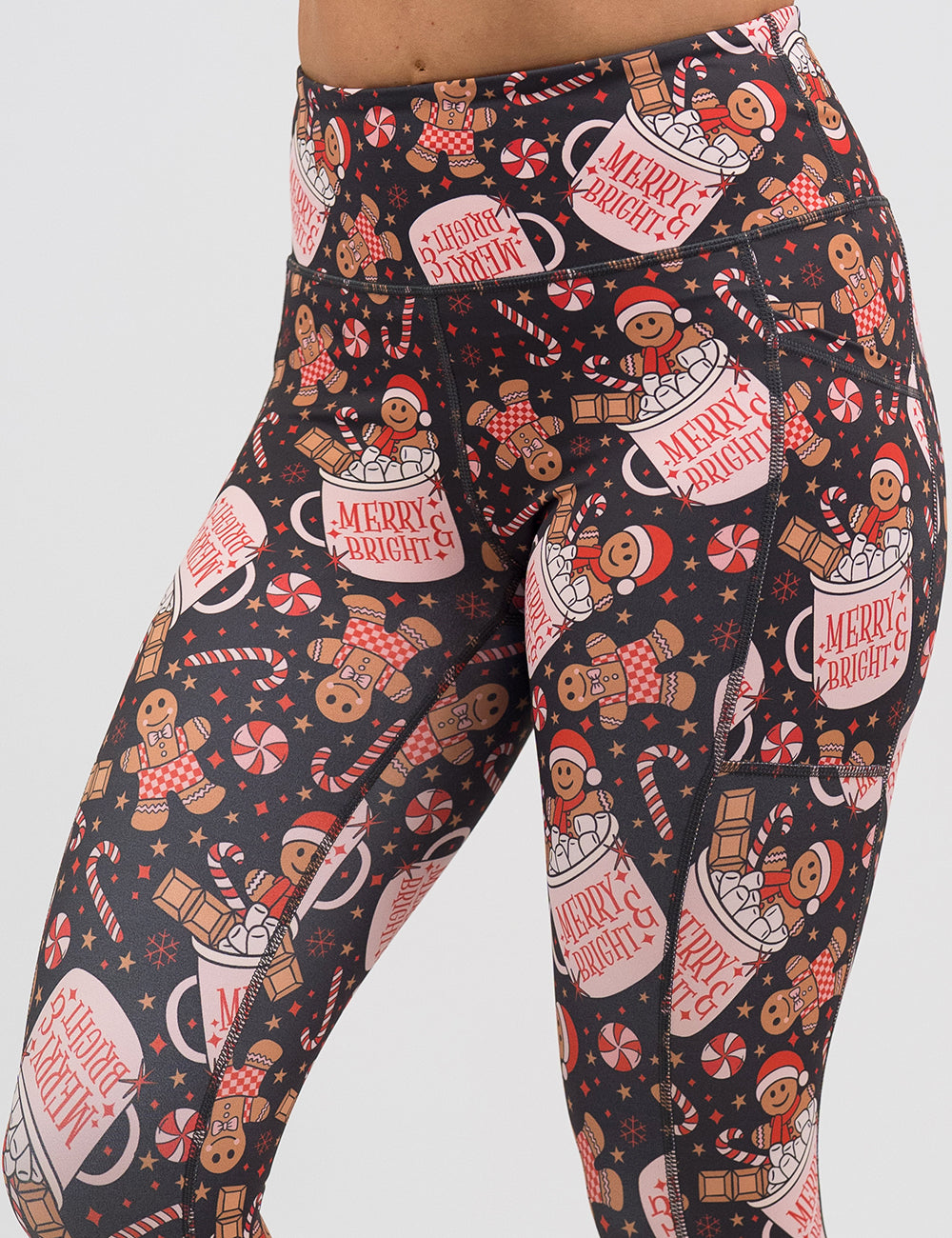 close up of the Christmas-themed leggings with gingerbread men and candy canes