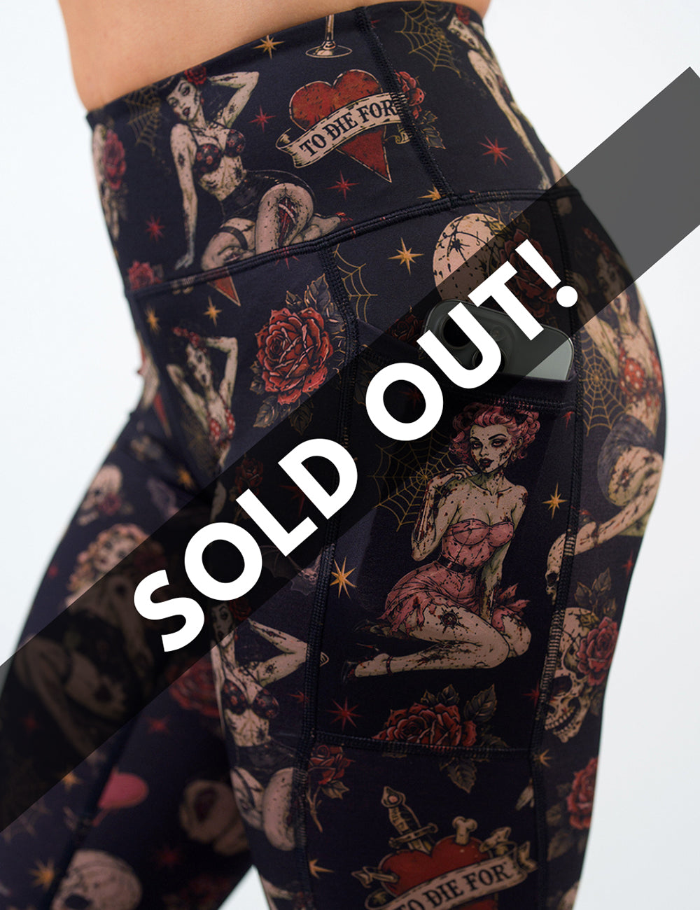 side of the zombie girls with pin up hair and traditional tattoo design leggings with a phone in its pocket against a white background, sold out