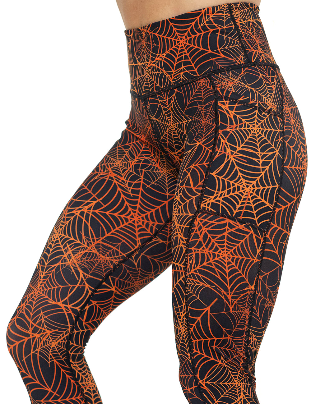 front of the orange spider webs against a black background leggings against a white background