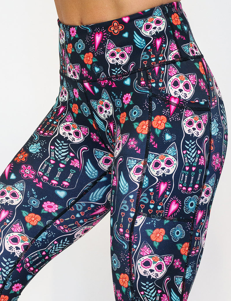 front of the cartoon skeleton cat print leggings against a white background