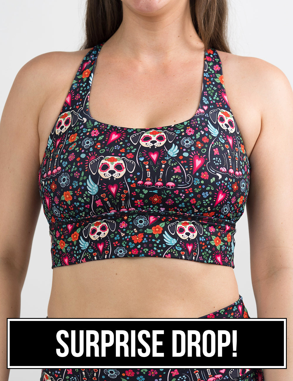 front of the skeleton dogs surrounded by flowers bra, surprise drop