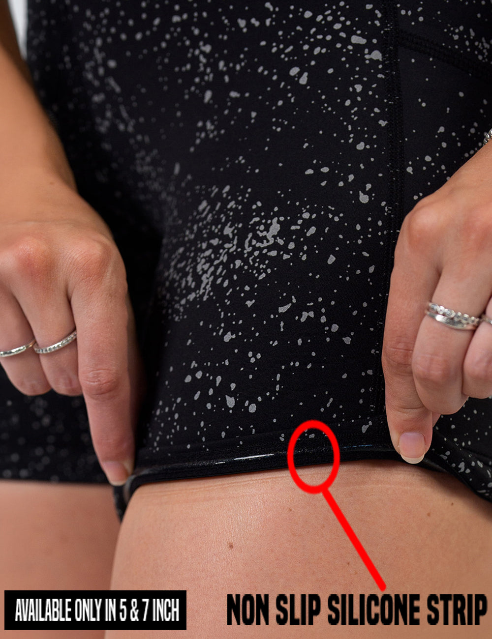 close up of the black shorts with reflective spots bring rolled up to show the non slip silicone strip found in only the 5 and 7 inch shorts
