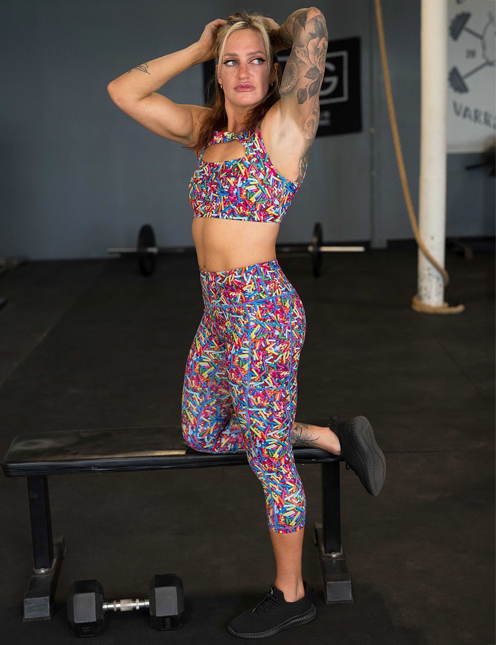 model wearing the rainbow sprinkles pattern capri leggings in the gym