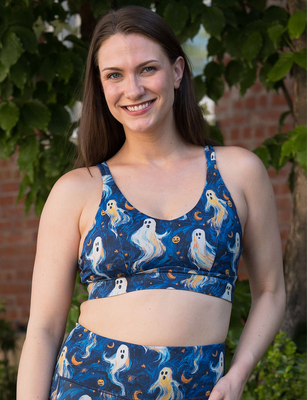 model wearing the starry night ghosts against a blue background pattern bra