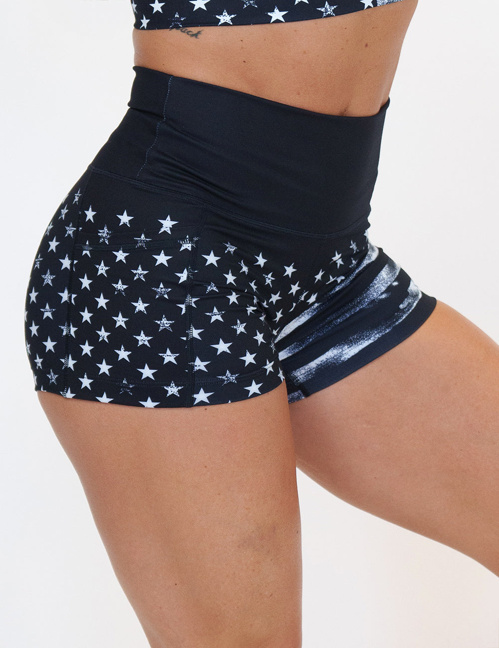 front of the 2.5 inch black shorts with white stars and stripes against a white background