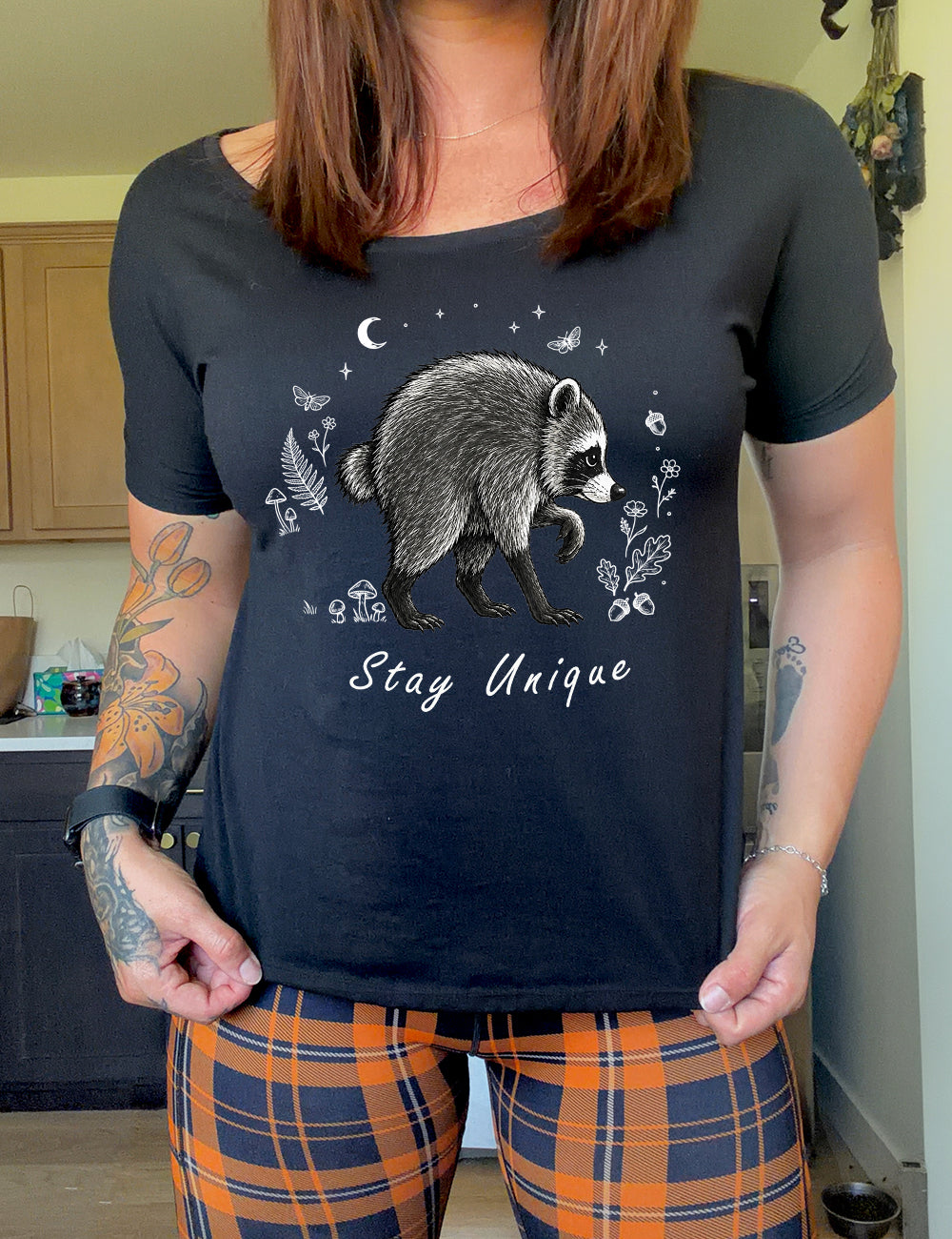front of the black "stay unique" raccoon  slouchy tee 