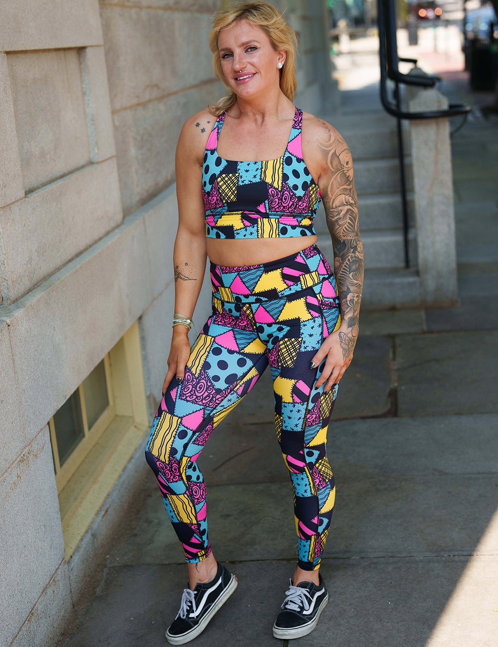 model wearing the yellow, teal, and pink patchwork design full length leggings