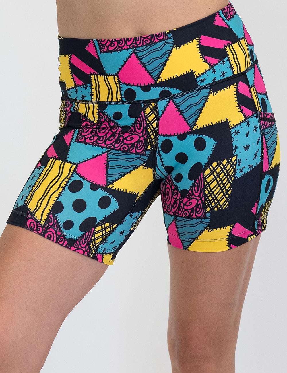 front of the 5 inch yellow, teal, and pink patchwork design shorts against a white background
