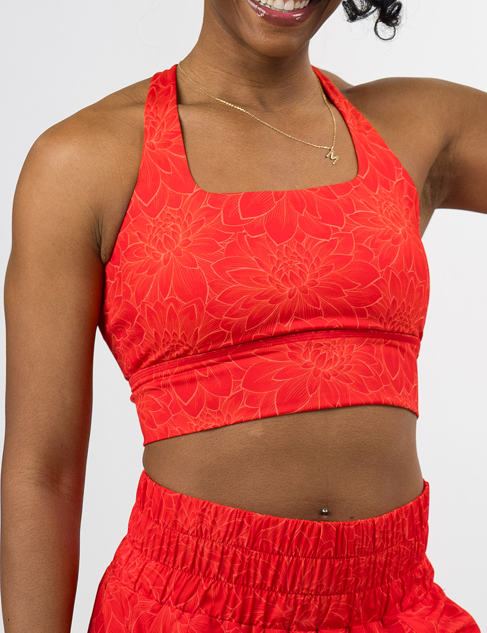 front of the orange lotus longline bra against a white background