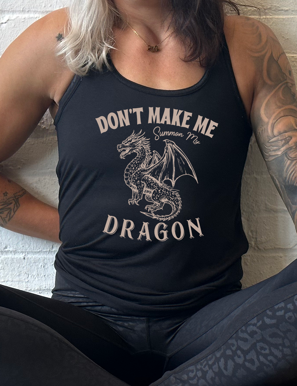 black racerback flowy tank with the words "don't make me summon my dragon" on it, surrounding the graphic of a fierce-looking dragon