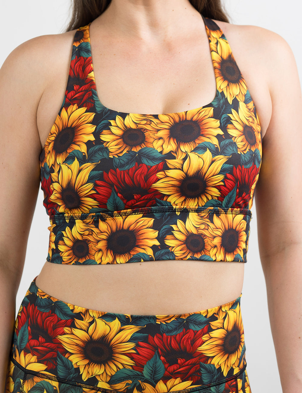 front of the sunflower with red flowers bra against a white background